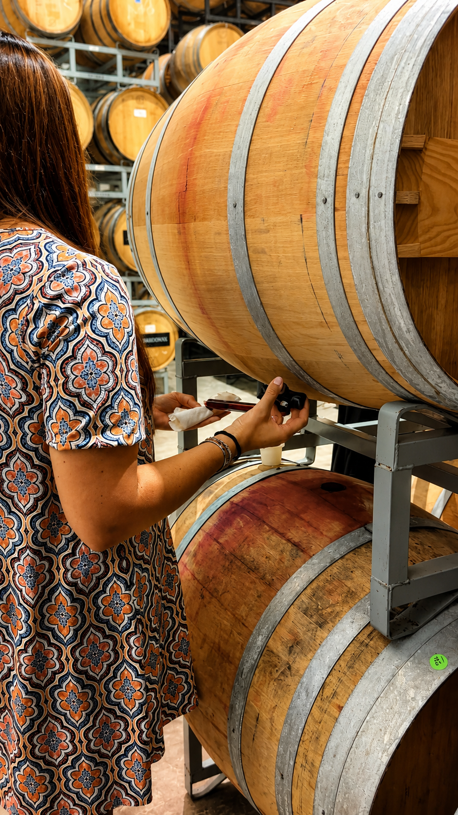 Guest tasting wine directly from a barrel
